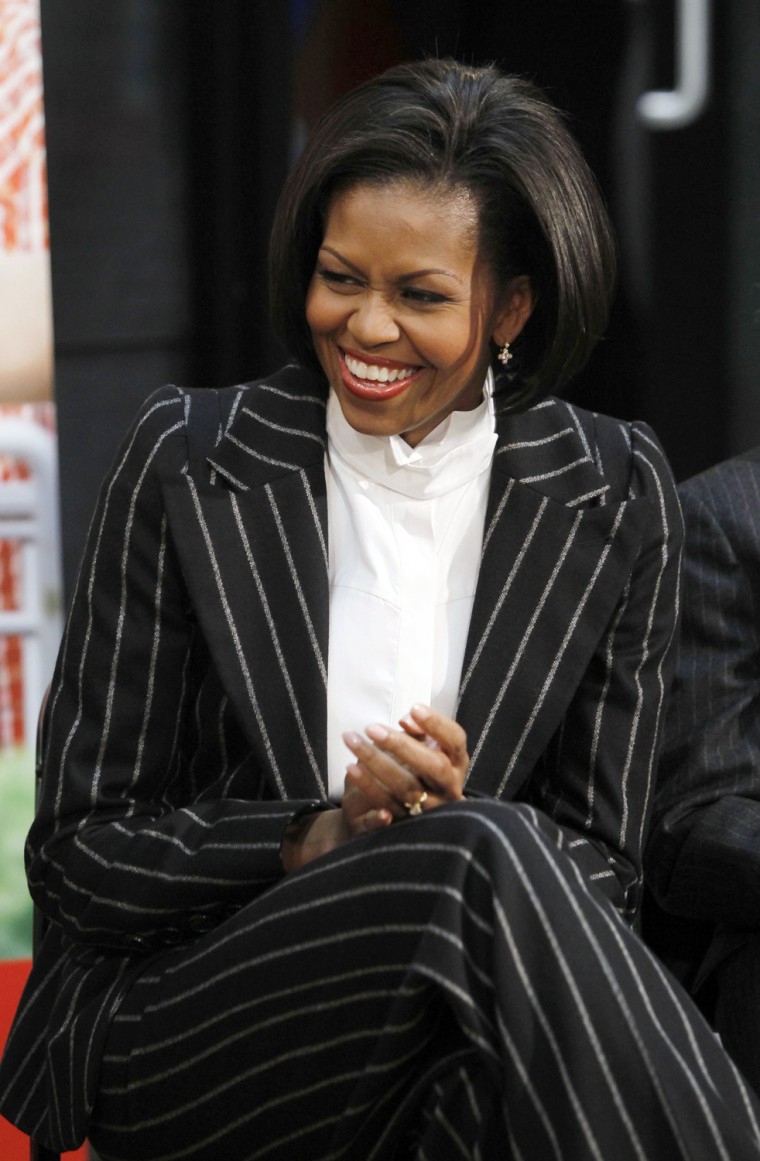 Image: U.S. first lady Michelle Obama laughs at a YMCA event in Alexandria